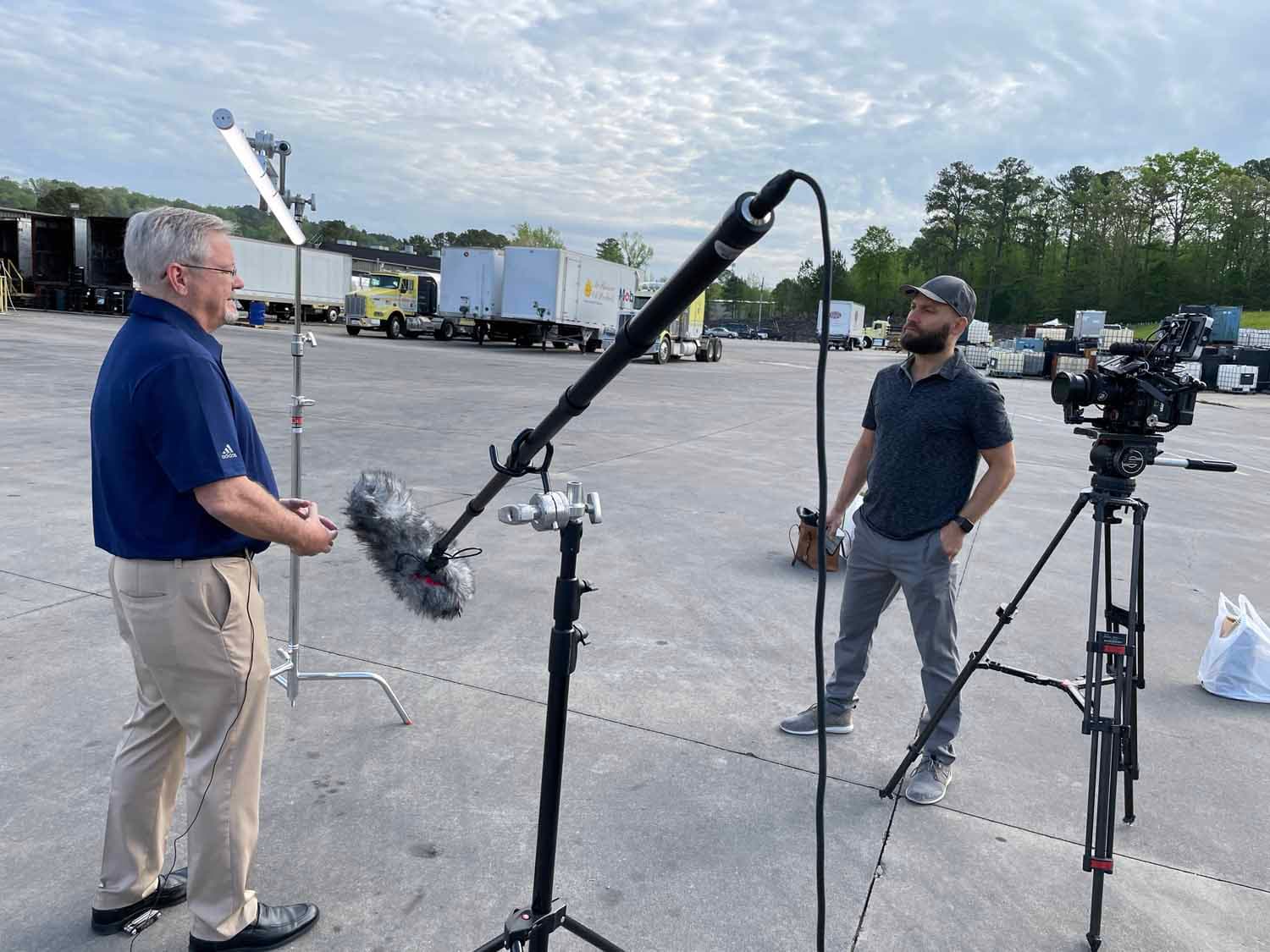 A video producer asks questions on a corporate video shoot